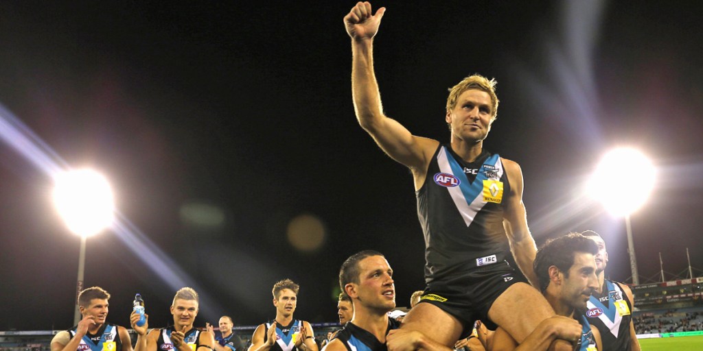 Cornes celebrating his 250th game in 2013. AAP photo