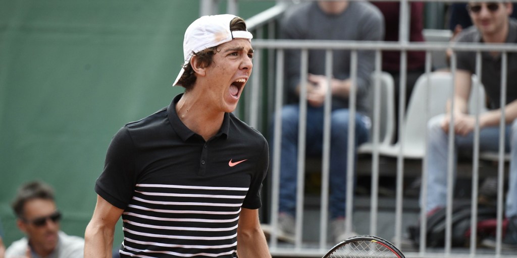 Australia's Thanasi Kokkinakis celebrates after defeating compatriot Bernard Tomic during the men's second round at the Roland Garros.