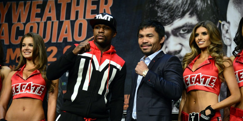Pre-fight hype: Floyd Mayweather and Manny Pacquiao pose with models ahead of the weekend's bout.