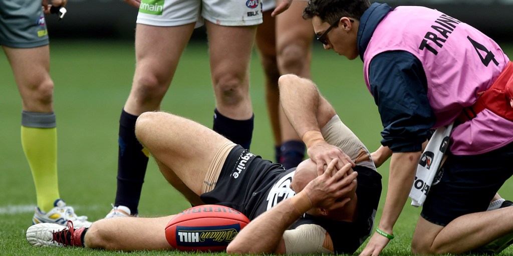 Chris Judd lies on the ground after injuring his knee during Saturday's match. Photo: AAP