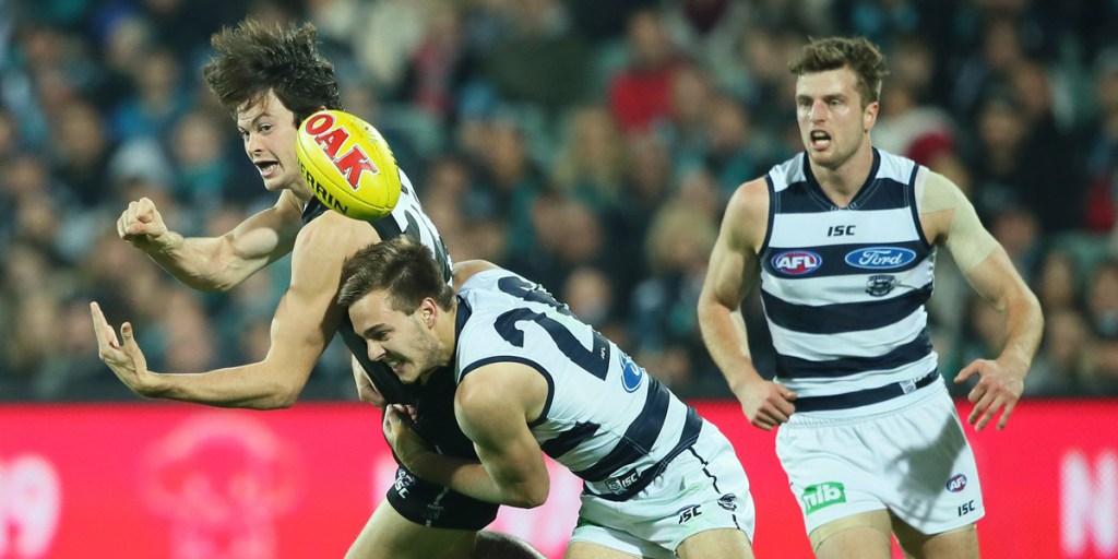 Jasper Pittard is tackled by Cory Gregson in Friday's game at Adelaide Oval. Photo: AAP