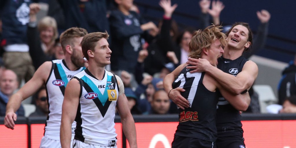 Dennis Armfield celebrates after scoring a goal for Carlton against the Power.