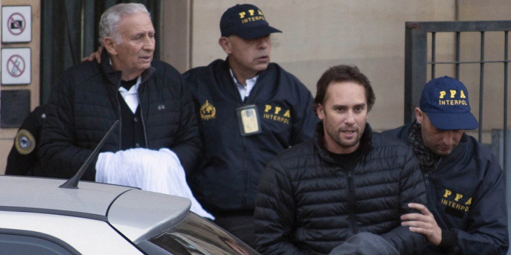 Father and son Hugo and Mariano Jinkis leave court in Buenos Aires.