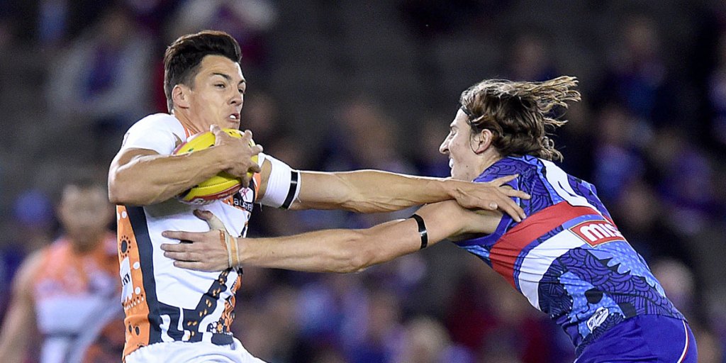 Dylan Shiel (left) tangles with Bulldog Marcus Bontempelli.