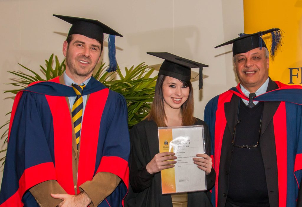 Zoe Horton flanked by Dr Michael Savvas (left) and Associate Professor Salah Kutieleh at the Foundation Studies completion ceremony