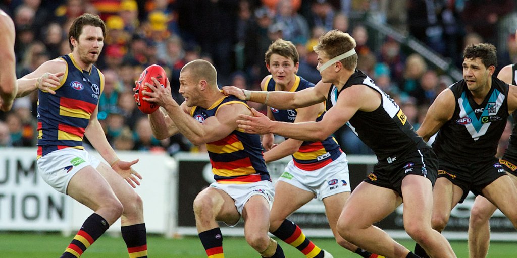 Best-on-ground Scott Thompson tries to evade Port's Ollie Wines. Photo: Michael Errey/InDaily