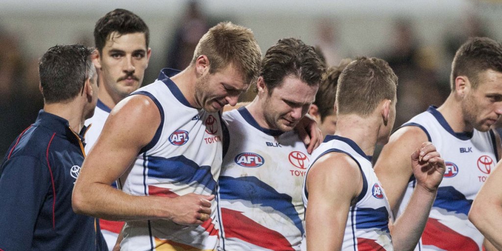Emotional Crows players leave the field after their defeat.
