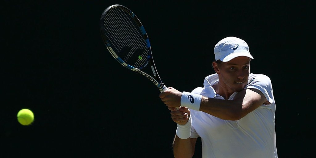 Australia's James Duckworth returns to Tunisia's Malek Jaziri during their men's singles first round match.