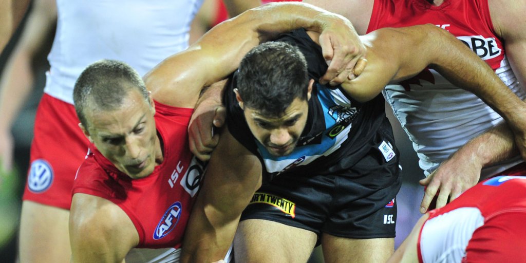 Paddy Ryder tussles with Swans backman Ted Richards during a match in Adelaide in April.