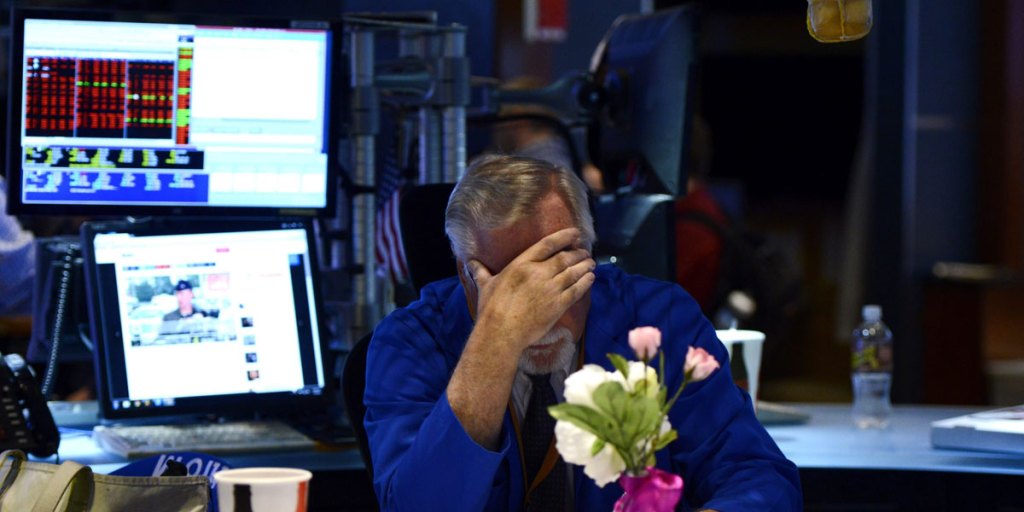 A trader sits at his desk after trading was halted due to a technical glitch in New York.