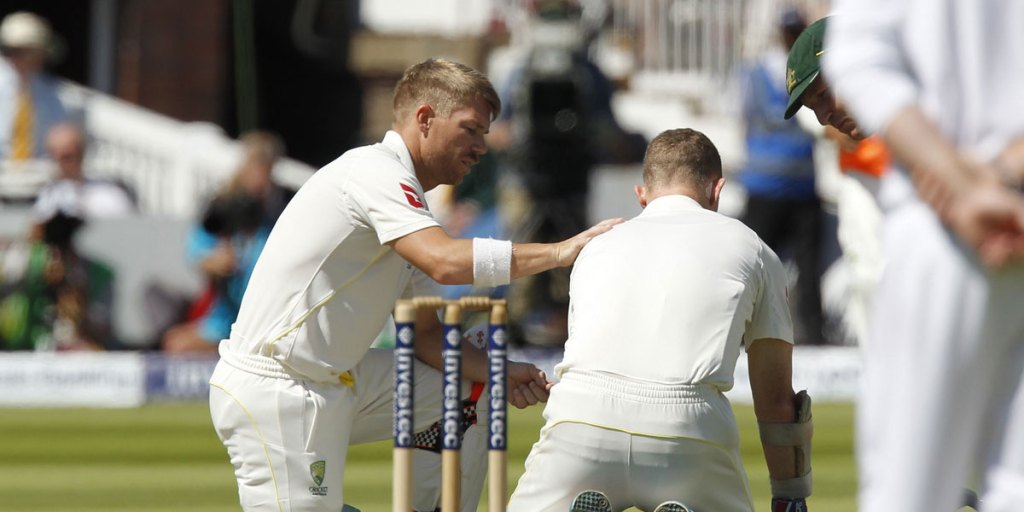 David Warner checks on Chris Rogers after the opener suffered a dizzy spell at Lord's.