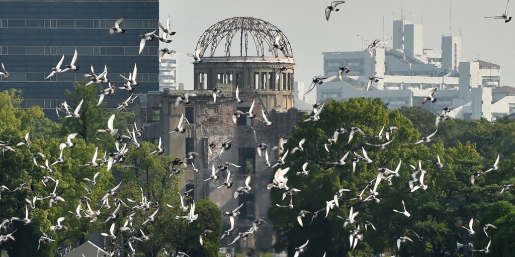Doves fly over the Hiroshima Peace Park during a memorial ceremony. Photo: AAP 