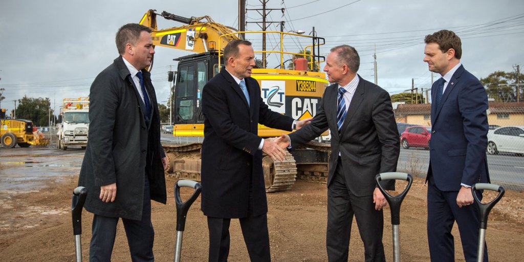 Prime Minister Tony Abbott shakes hands with Premier Jay Weatherill as Jamie Briggs (left) and Stephen Mullighan (right) look on.