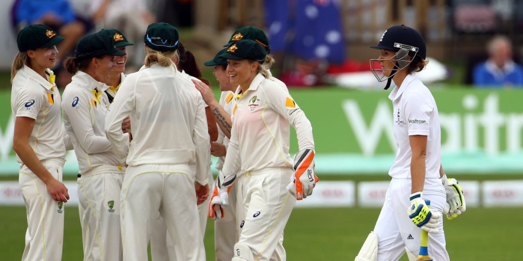 England Captain Charlotte Edwards (right) leaves the field after losing her wicket to Australia's Megan Schutt.