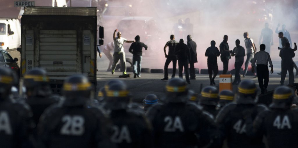 Not a metaphor: French taxi drivers confront police at a protest against Uber in Paris in June.