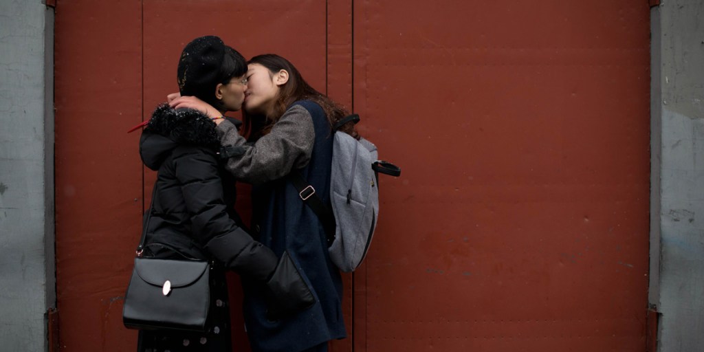Two women kiss outside a registry office in Beijing in a bid to draw attention to discrimination against LGBTQ people. Photo: AAP