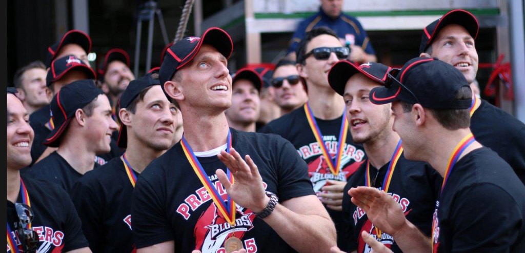 Chris Schmidt and the West Adelaide team at the unveiling of the Bloods' colours on the West End brewery chimney yesterday. Photo: Peter Argent