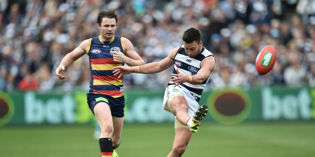 Adelaide's Patrick Dangerfield fails to prevent Jimmy Bartel getting his kick away. AAP image