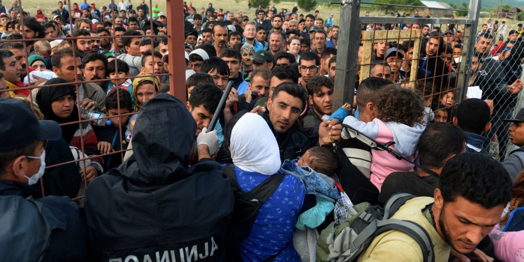 Migrants break through the cordon of Macedonian police forces, near the town of Gevgelija, in The Former Yugoslav Republic of Macedonia, 07 September 2015. EPA image