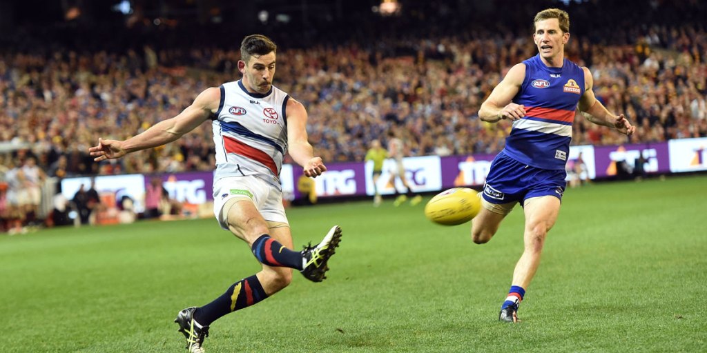 Crows captain Taylor Walker sends the ball on its way to Charlie Cameron in the dying moments of the elimination final. AAP photo