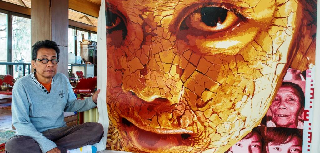 Indonesian community artist Moelyono, pictured this week at the Pendopo Javanese cultural pavilion at Flinders University, Bedford Park, with one of his eye-catching portraits.  