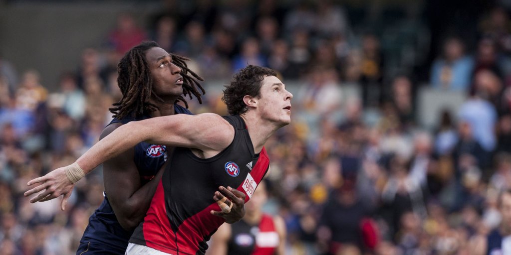Essendon's Jake Carlisle holds his position in front of West Coast's Nic Naitanui. AAP photo