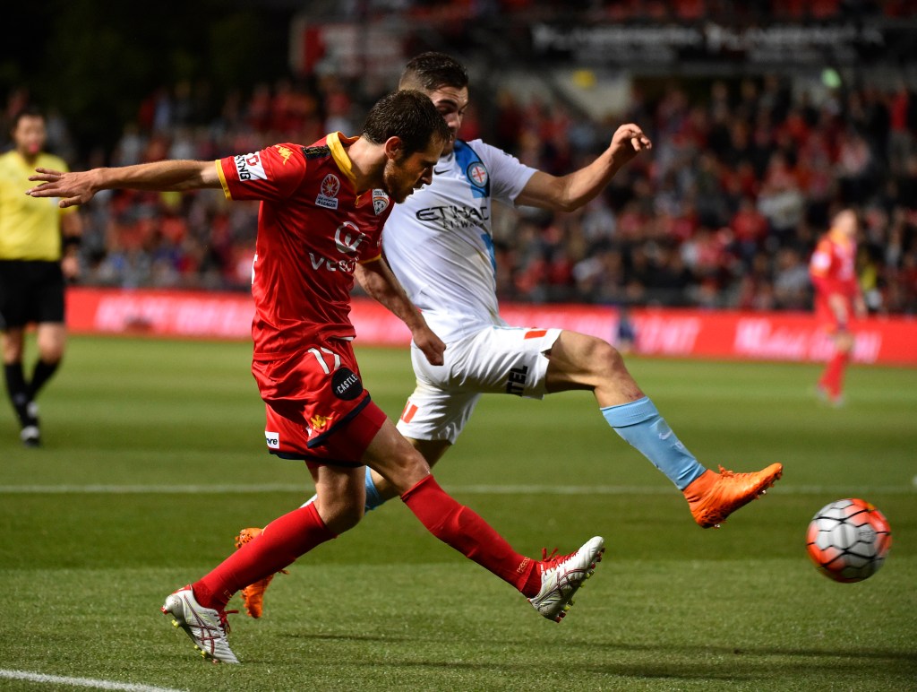 United's Mate Dugandzic takes on Ben Garucio of Melbourne City.