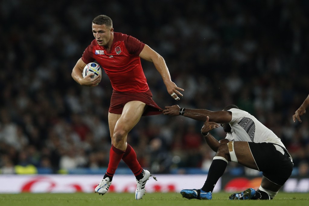 Sam Burgess is tackled by Fiji's Sakiusa Matadigo during a Pool A match of the 2015 Rugby World Cup.
