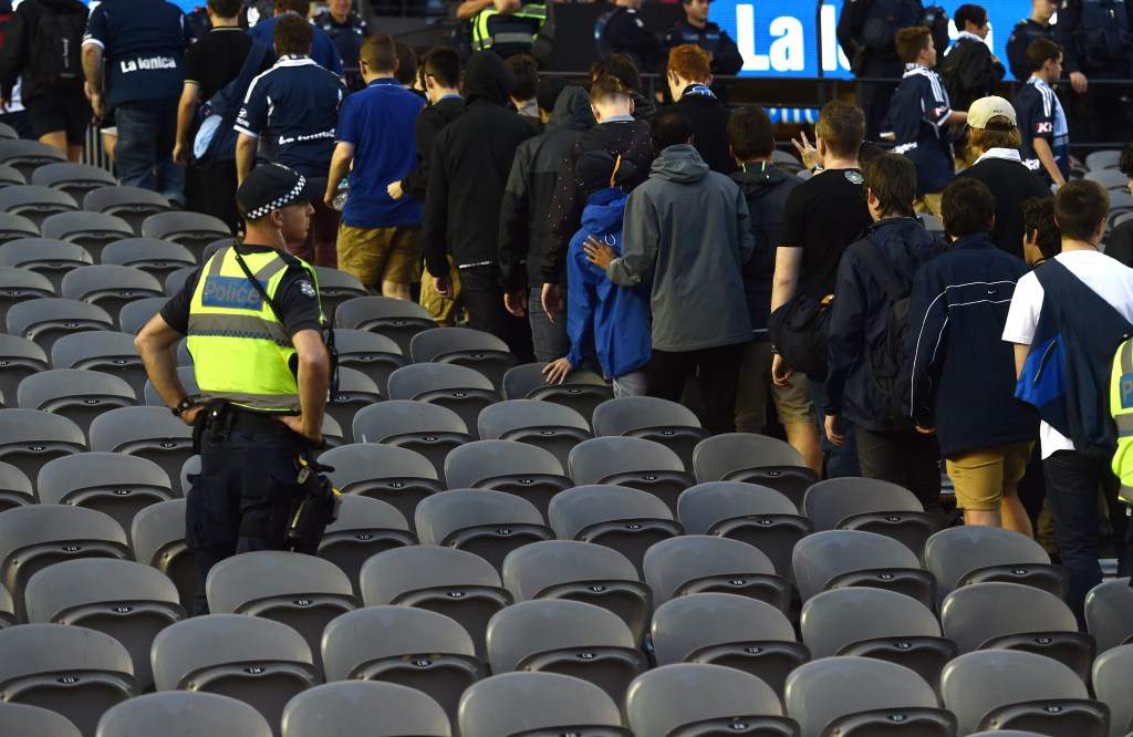 Melbourne Victory fans walk out at the 30th minute of the match against Adelaide United. AAP Image/Tracey Nearmy