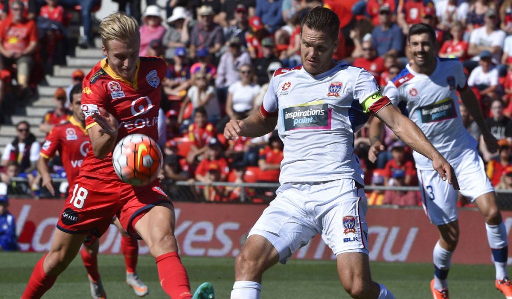 Jimmy Jeggo of United and Nigel Boogaard of the Jets during Sunday's match at HIndmarsh. Photo: AAP Image/David Mariuz