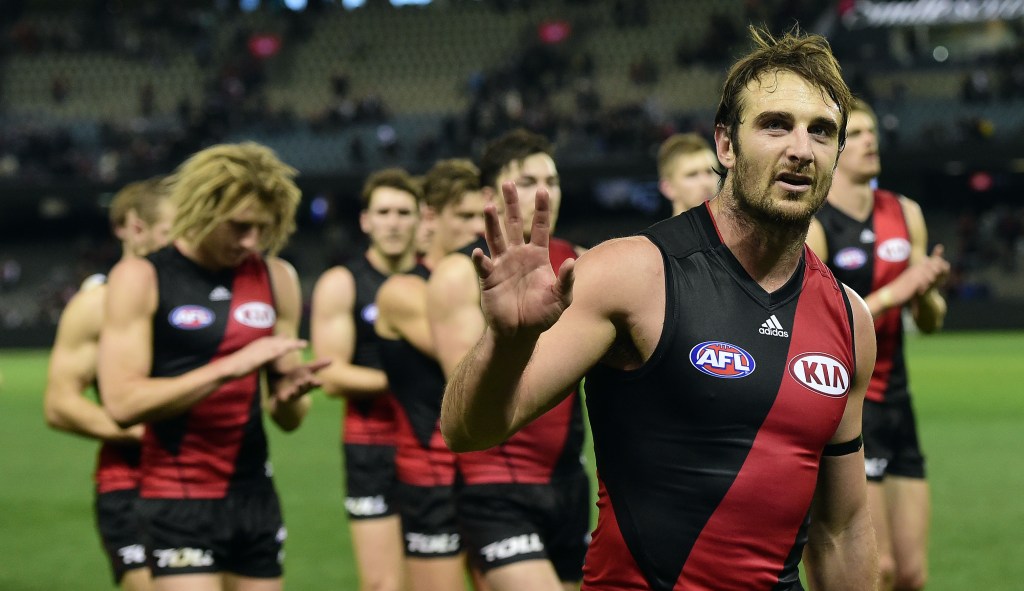 Jobe Watson leads his teammates off the field after a defeat last year. Neither he nor 16 other players will take the field this year. Photo: Julian Smith, AAP.