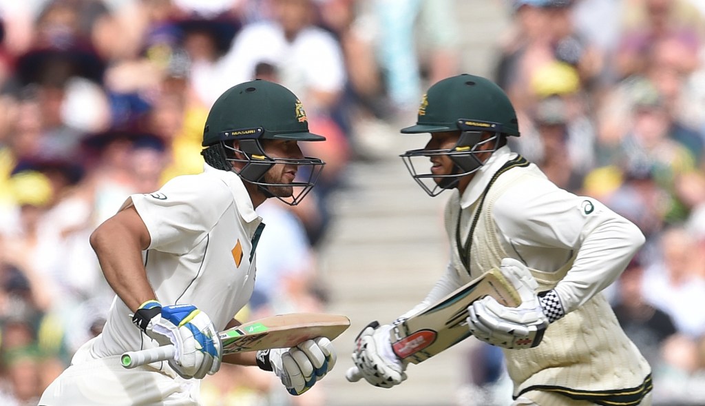 Joe Burns and Usman Khawaja cross paths as they charge towards centuries against the West Indies at the MCG. Photo: Tracey Nearmy, AAP.