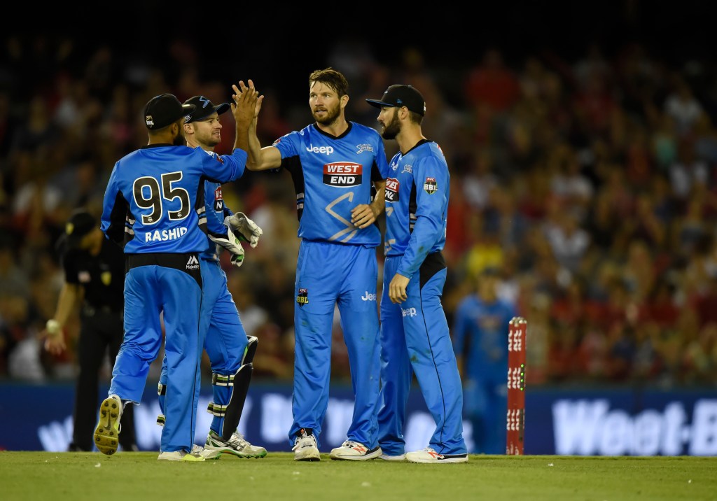 Michael Neser is mobbed by teammates during the Strikers' victory over the Renegades on Monday. Photo: Mal Fairclough, AAP.