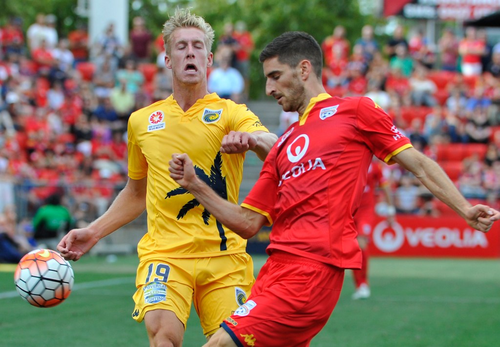 La Rocca contests the ball with Central Coast's Josh Bingham last month. Photo: David Mariuz, AAP.