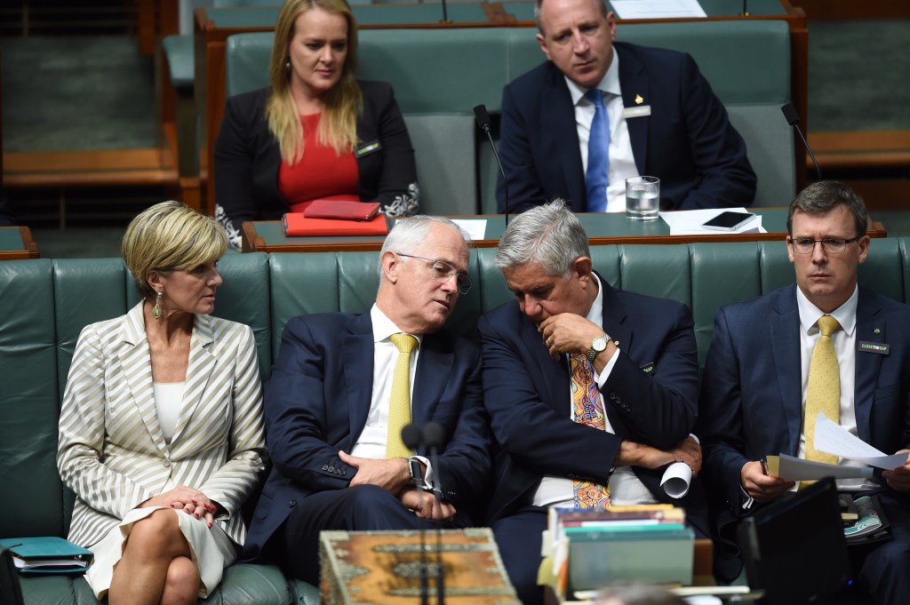 Prime Minister Malcolm Turnbull (centre left) speaks to indigenous parliamentarian Ken Wyatt (centre right) after delivering the annual Closing the Gap address . Photo: AAP/Lukas Coch