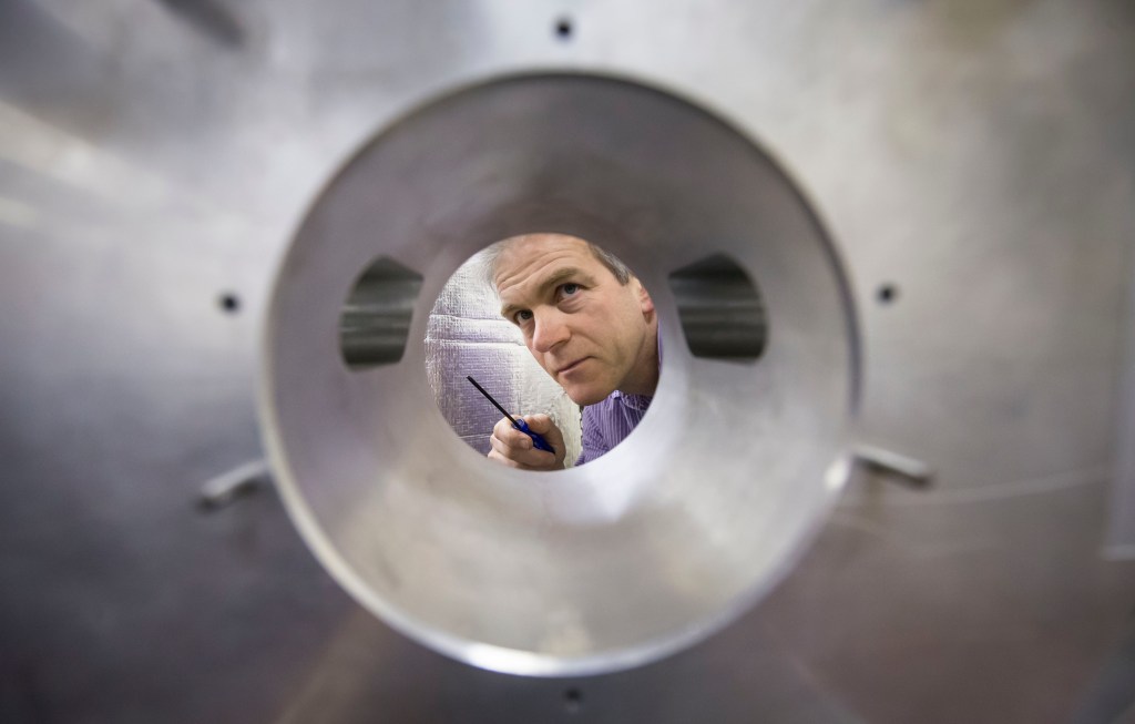 Dr Angus Bell at the Institute of Gravitational Research, University of Glasgow, with a model of the LIGO Detector as the announcement of the detection of gravity waves - ripples in spacetime - was made. Photo: Danny Lawson/PA Wire
