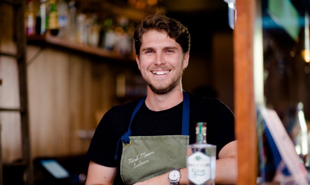 Boutique gin distiller Ty Swan behind the bar at Pink Moon Saloon.