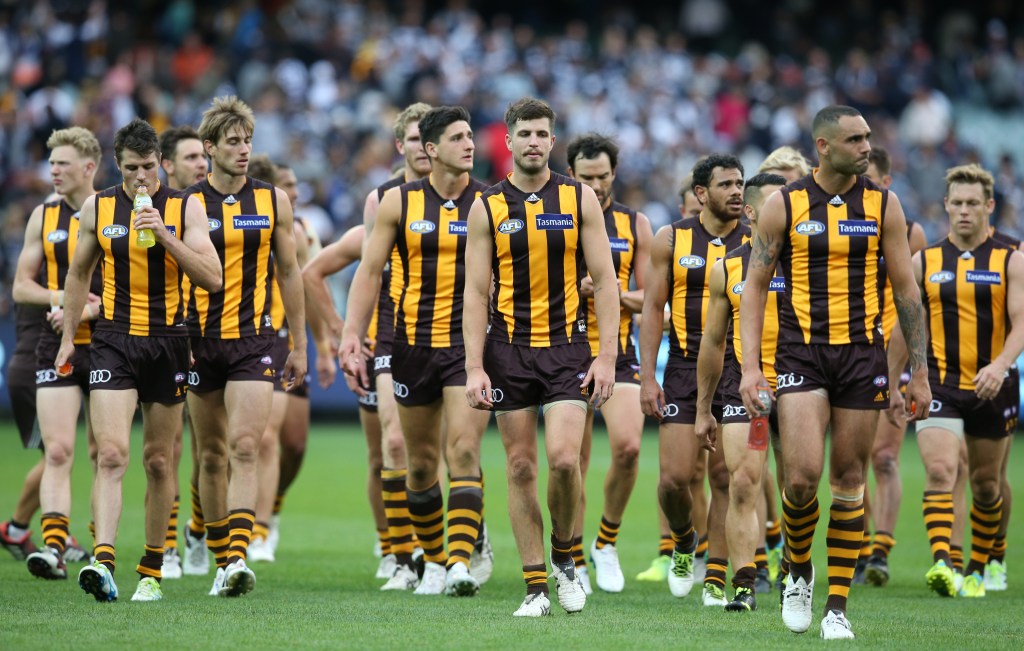 Dejected Hawthorn players leave the field after yesterday's loss to Geelong. Photo: David Crosling, AAP.