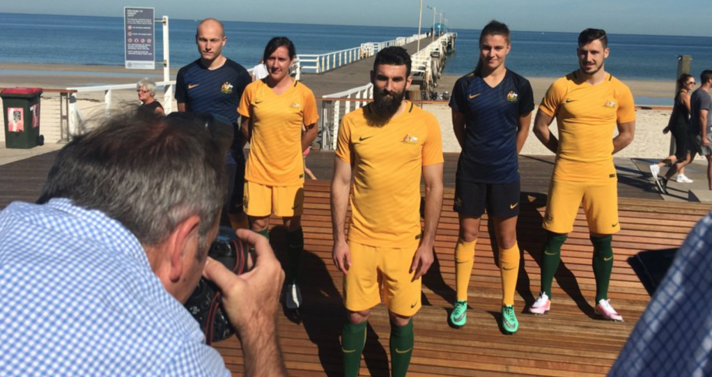 Socceroos and Matildas stars show off their new playing strip at Henley Beach. Photo: Socceroos, Twitter.