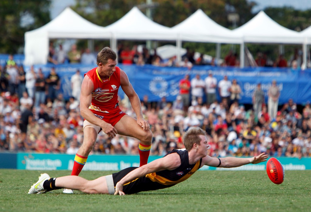 Nathan Bock takes on Richmond's Jack Riewoldt in one of 27 games for the Suns. Photo: AAP.