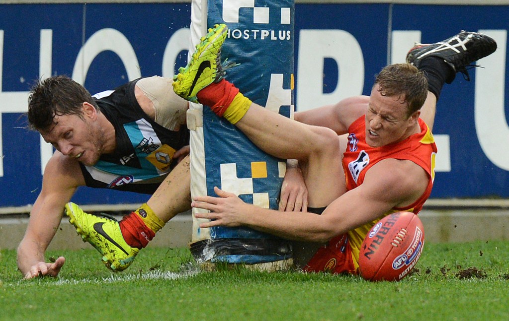 What will a Chinese audience make of this? Port Adelaide's Brad Ebert and Suns player Brandon Matera collide with the goal post.  Photo: Dave Hunt, AAP.