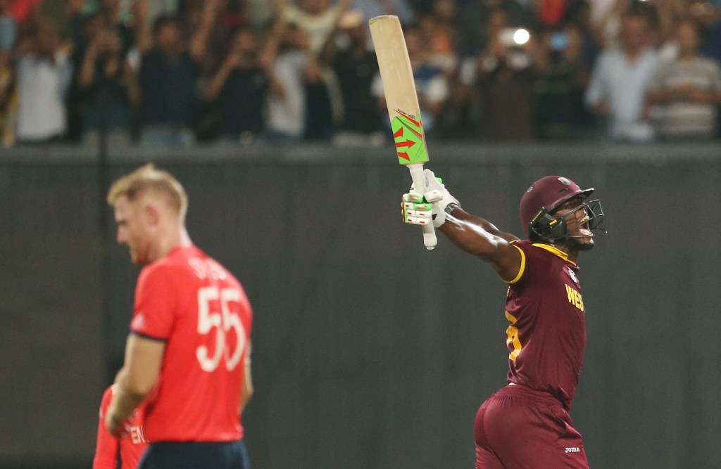 A TALE OF TWO TEAMS: A despondent Stokes and victorious West Indies batsman Carlos Brathwaite. Photo: Bikas Das, AAP.