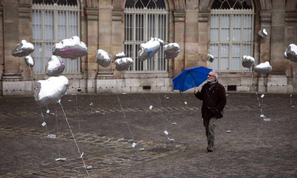 A man watches-cloud shaped balloons during a demonstration  in Paris against the use of nuclear power plants on the eve of the 30th anniversary of the Chernobyl disaster. Photo: EPA