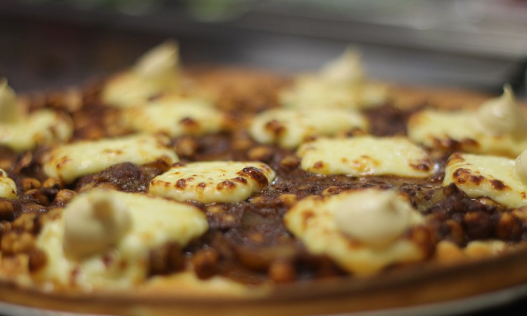 Pizza with haloumi and backyard lime aioli topping.