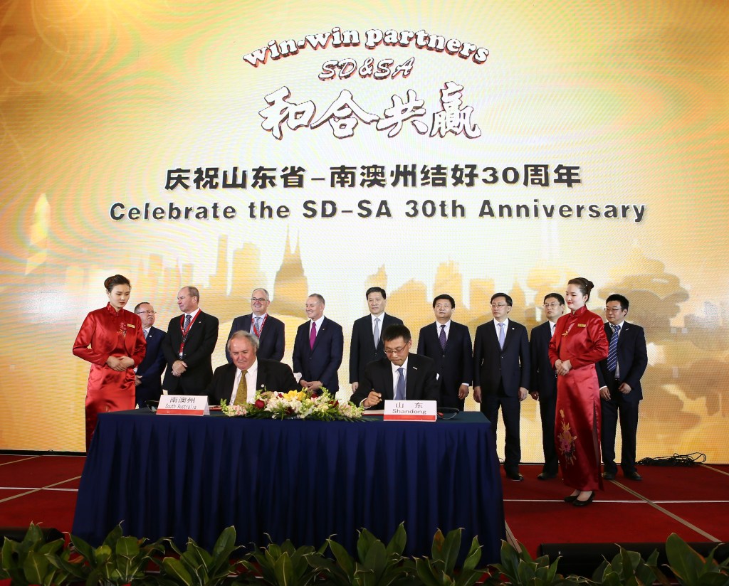 Jay Weatherill and other delegates sign an agreement with ICT company Inspur on their China trade mission. Also on the trip are delegates from the three SA universities - and a businessman who says they should merge their operations. Photo: Supplied.