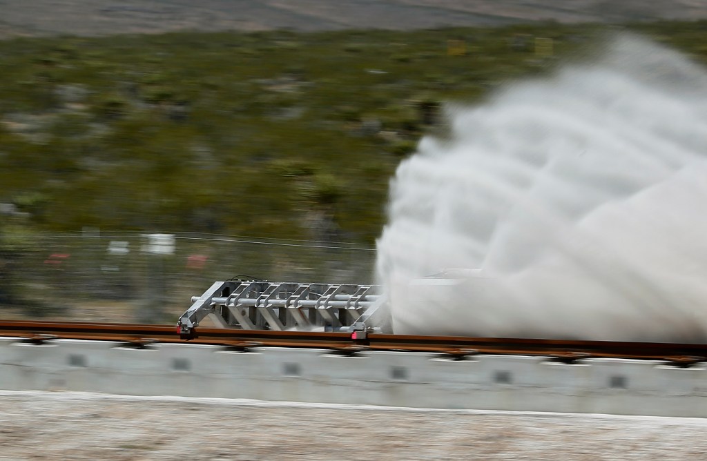 A sled speeds down a track during a test of a Hyperloop One propulsion system. Photo: AP/John Locher
