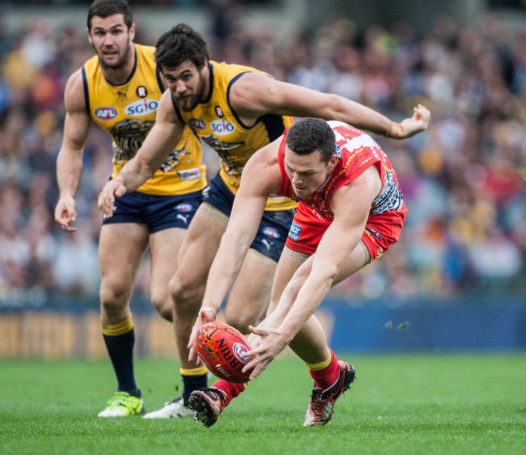 Steven May chases the ball, with Eagle Josh Kennedy in hot pursuit. Photo: Tony McDonough, AAP.