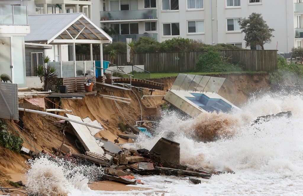 Waves crash against a  swimming pool that was washed away from a property at Collaroy in Sydney's Northern Beaches. Photo: AAP/David Moir
