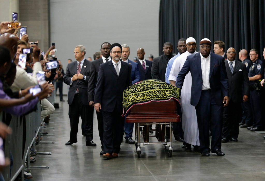 Muhammad Ali's casket arrives at Freedom Hall for his Jenazah, a traditional Islamic Muslim service, in Louisville. Photo: AP/David Goldman)