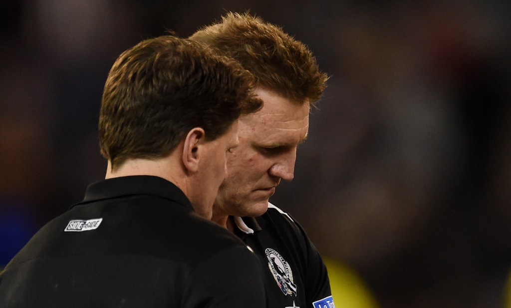 Nathan Buckley takes stock during Collingwood's capitulation to the Demons yesterday. Photo: Tracey Nearmy, AAP.